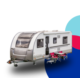 Caravan with table and chairs set up outside