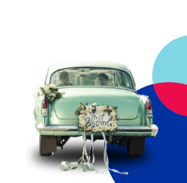 Classic car with bride and groom inside with flowers and just married on the back