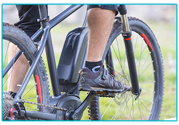 Close-up of man riding an e-bike