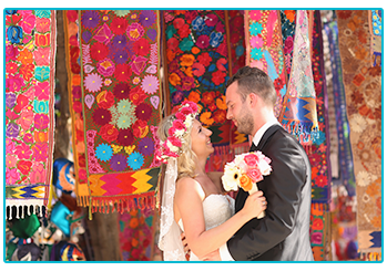 How to plan your wedding abroad on a budget - happy couple in a colourful bazaar or market