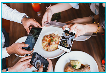 How to get amazing shots for Instagram on your phone! - Four people photograph their food. 