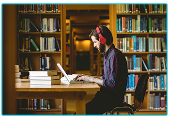 How to write a great dissertation - male student working in library
