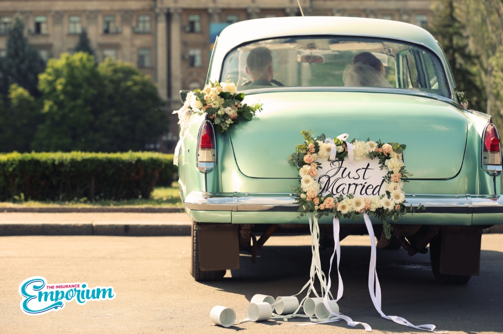 Wedding car driving off with the Bride and Groom in the front