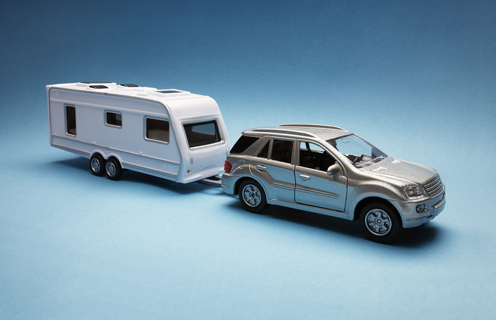 CRiS Numbers - Toy car towing a caravan of generic design on blue background