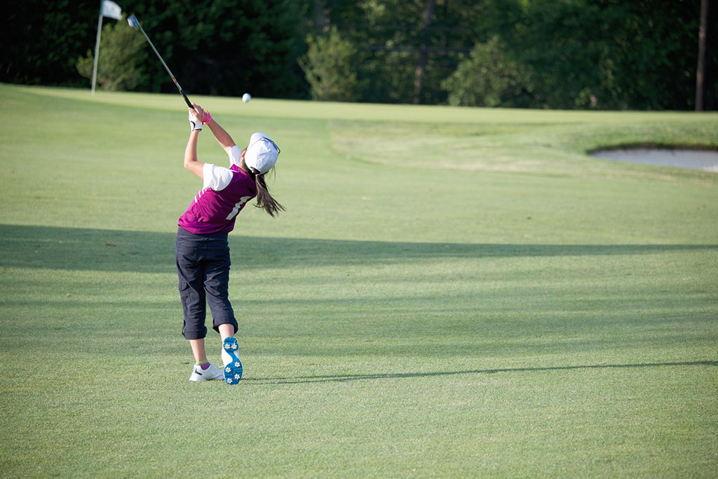 PERFECT GOLF SWING BY A 9 YEARS OLD GIRL PLAYING IN PGA JUNIOR LEAGUE GOLF / APPROACH SHOT FROM FAIRWAY WITH 8 IRON RIGHT ON TARGET( FLAG , PIN ) / MARYLAND / USA