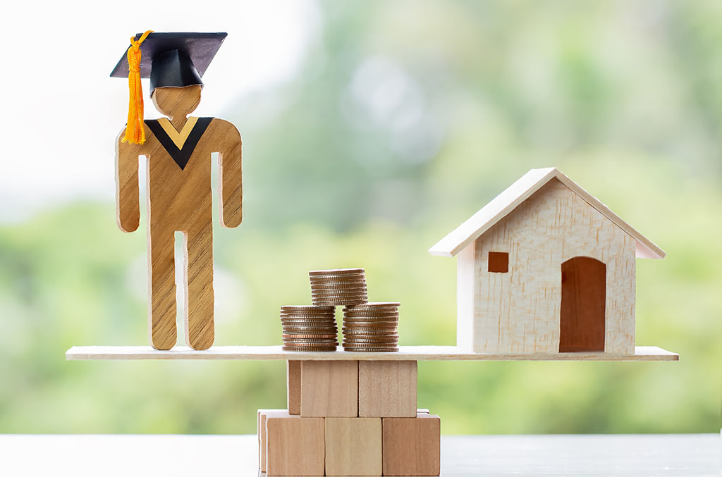 University Education learning abroad international Ideas. Student Graduation, coins and house on wood balance. Concept of study requires money cost saving, may be home loan, transform propery to cash.