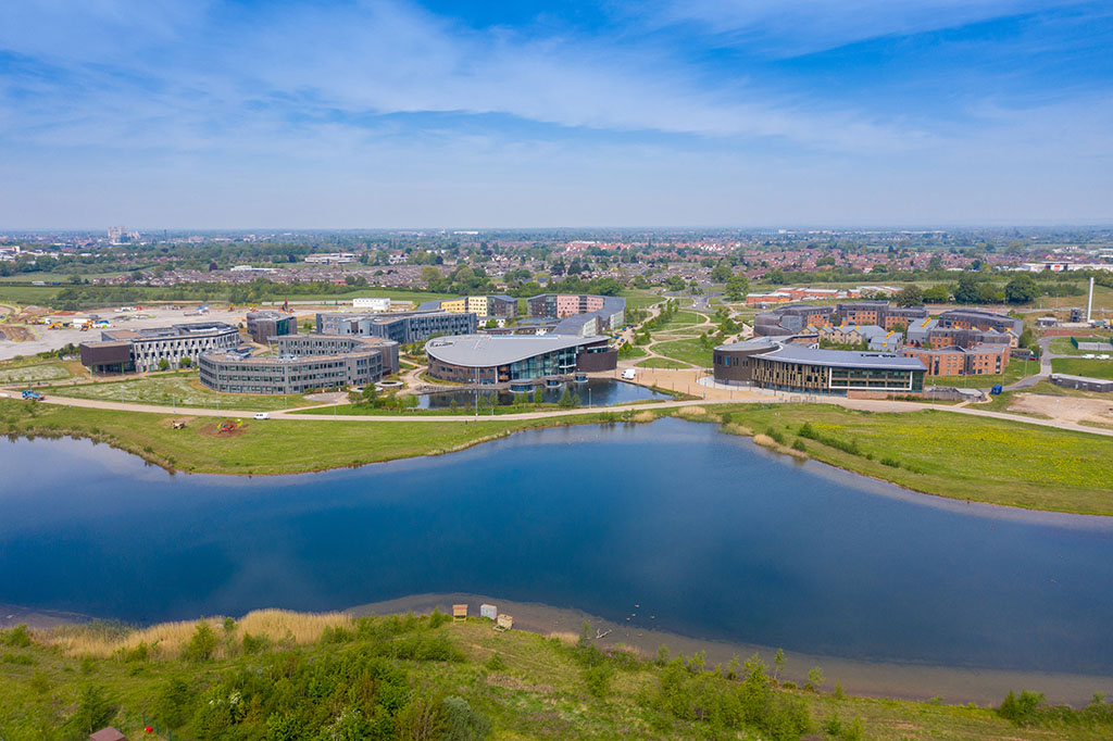 Aerial photo of the University of York, Campus East buildings in the City of York in North Yorkshire in the UK along side a lake on a sunny summers day taken with a drone