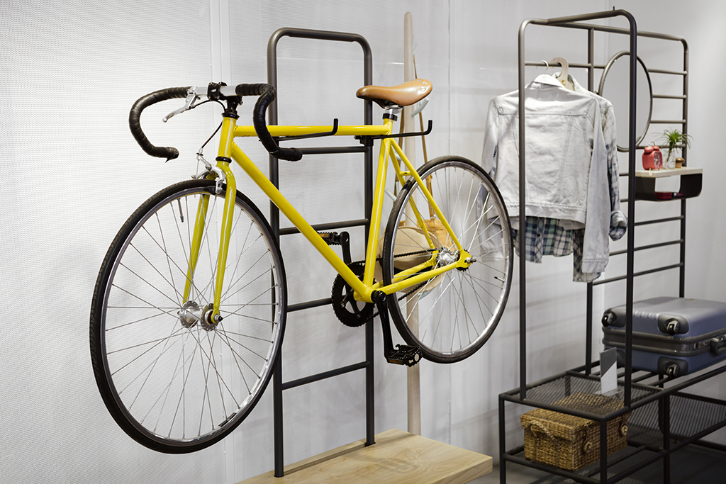a yellow bike on a floor rack as a storage idea 