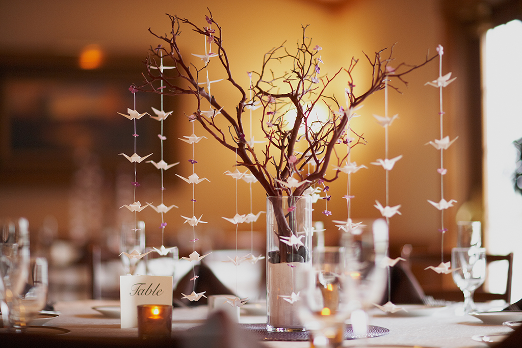 Wedding table setting with nature theme of bonsai tree and origami birds