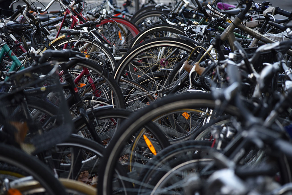 lots of bike wheels being stored outside