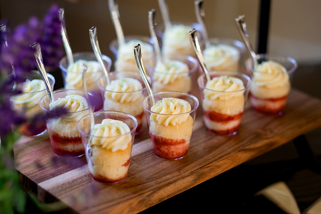 Mini cake cups at a wedding reception dessert buffet.