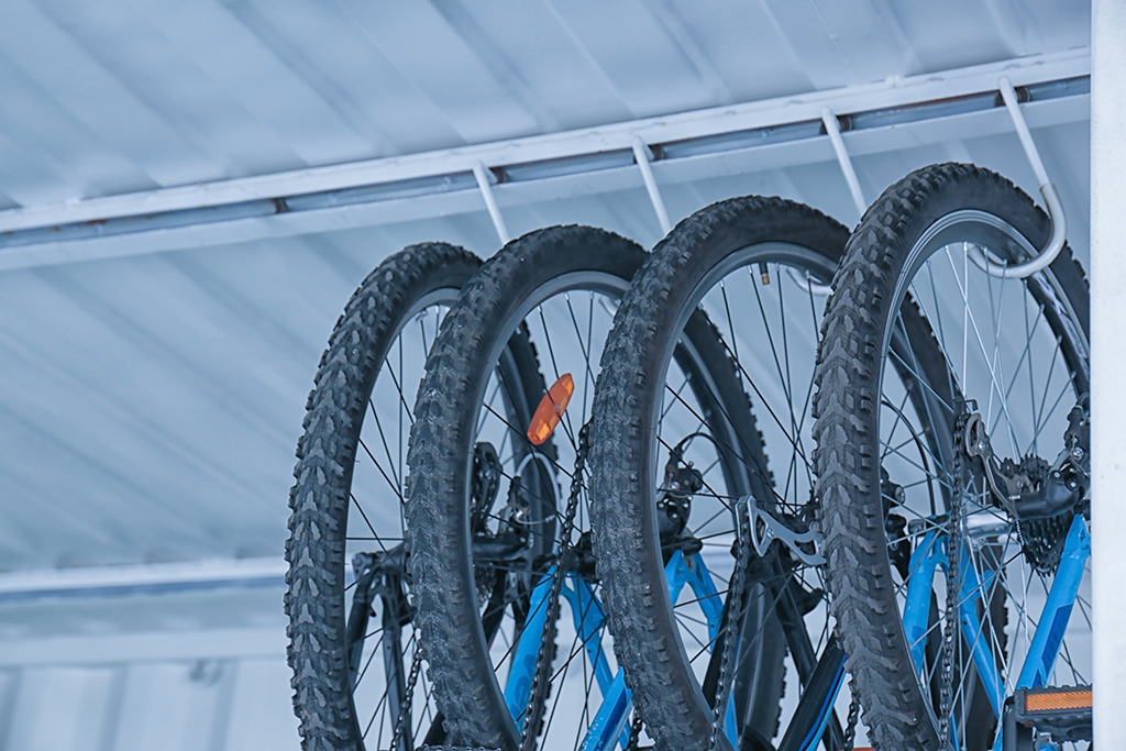 four bike tyres on a ceiling rack as a bike storage idea
