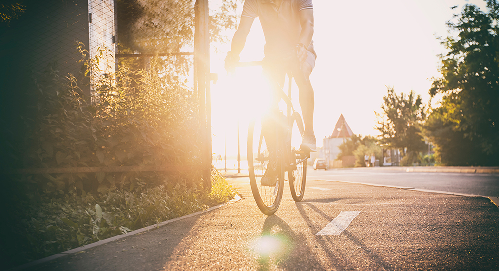Young Man Riding Bike Through City.