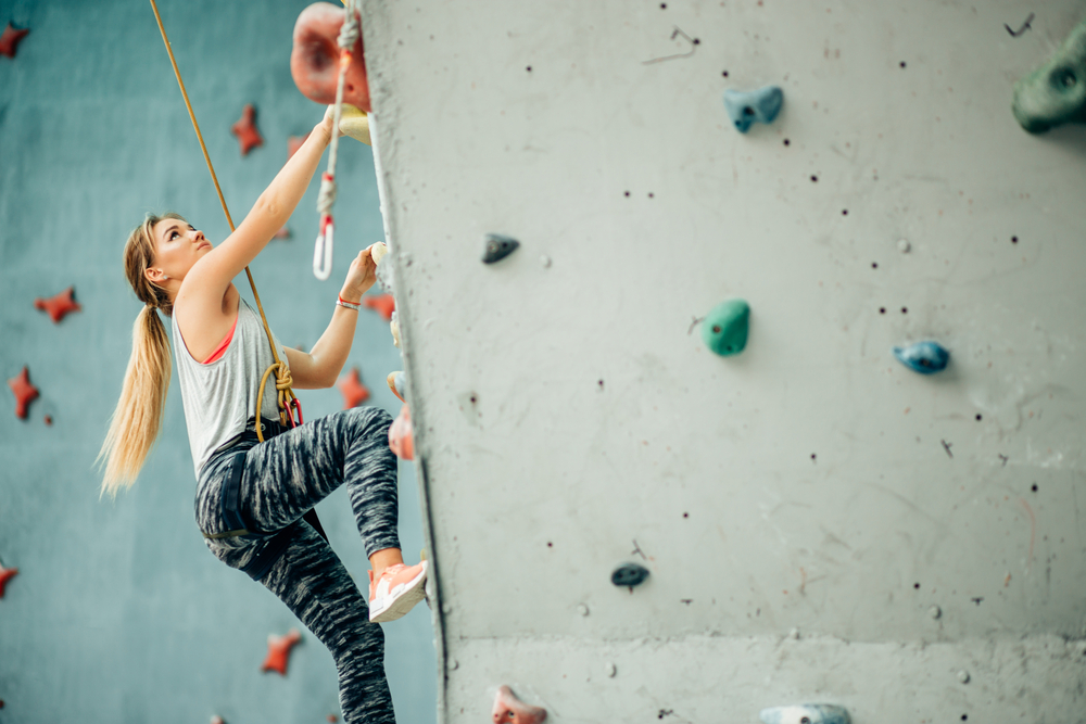 Free Climber Young Woman Climbing Indoor Wall.