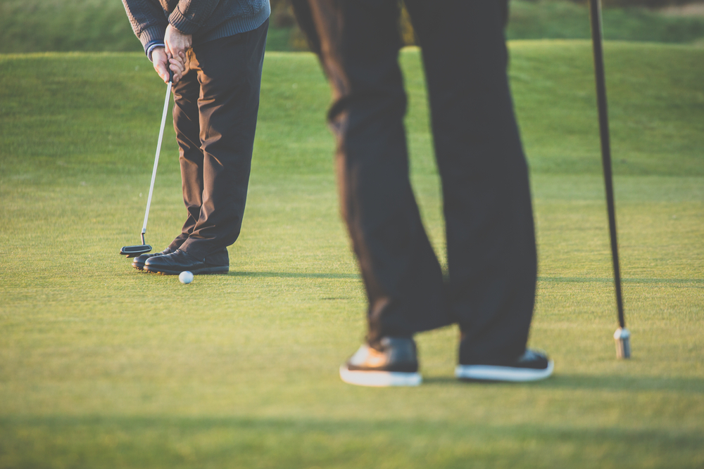 Golf Green Sceen Golfer Putting.