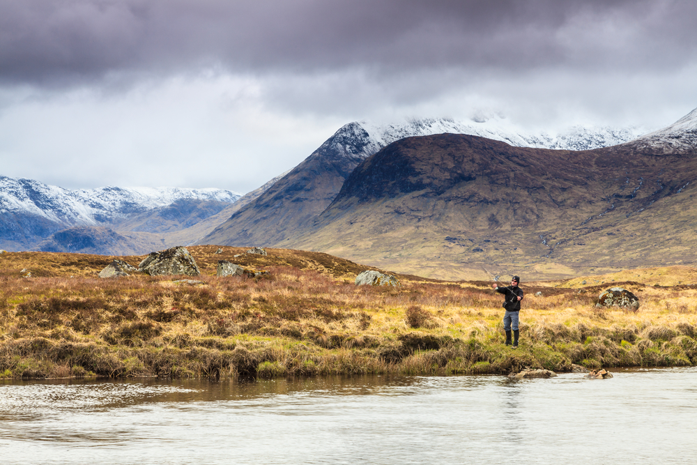Fly Fishing River Snow Covered Mountains.