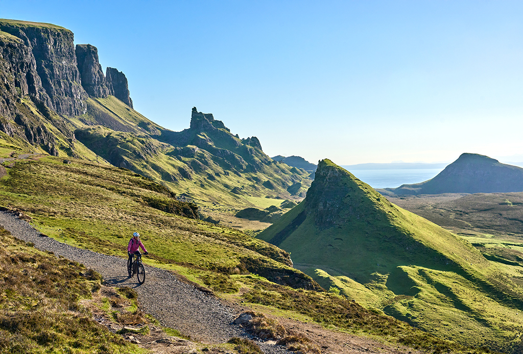 Woman riding her mountain bike in Highlands in Scotland.