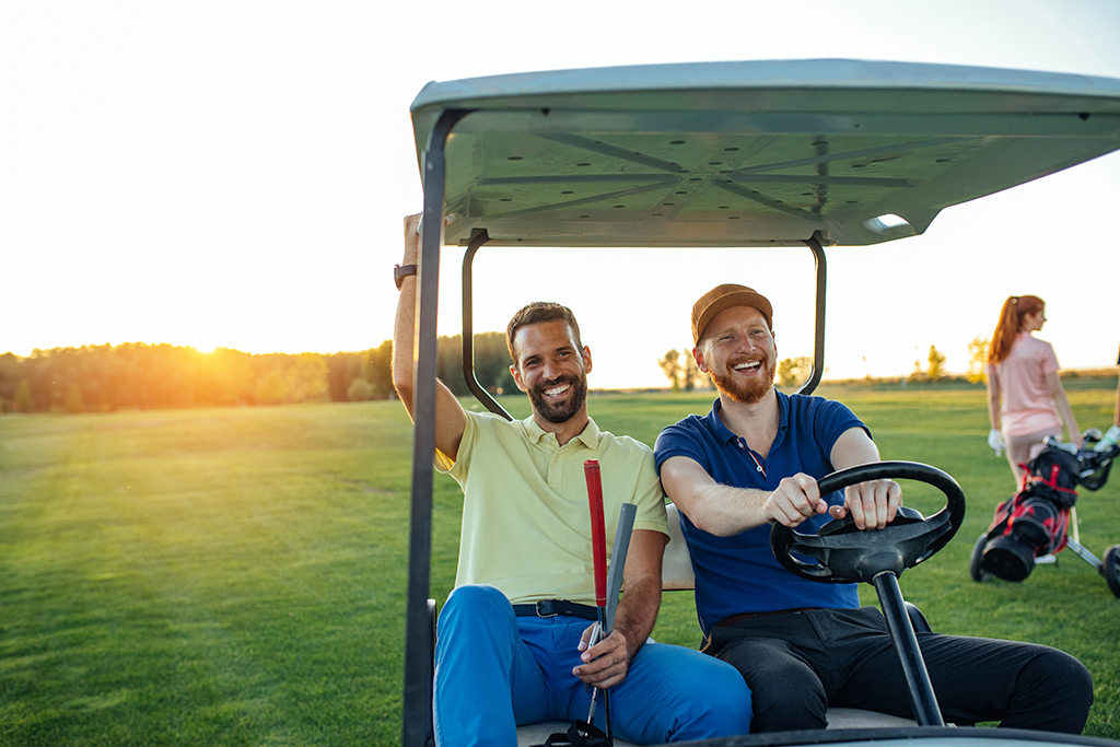 Young golfers driving cart and making golf jokes.