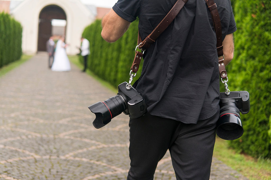 Professional Wedding Photographer With Insurance Takes Pictures Of Bride.